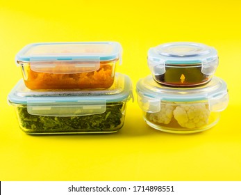 Stack Of Airtight Glass Food Containers With Colorful Cooked Vegetables On Bright Yellow Background. Meal Prep Concept