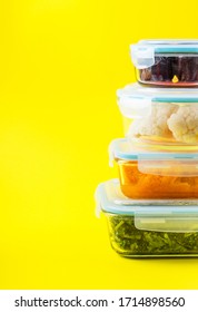 Stack Of Airtight Glass Food Containers With Colorful Cooked Vegetables On Bright Yellow Background. Meal Prep Concept