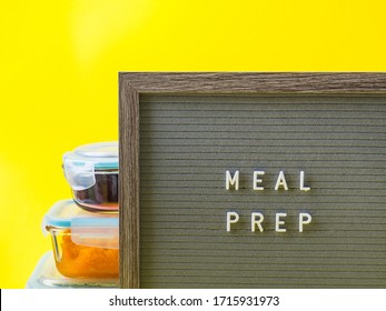 Stack Of Airtight Glass Food Containers With Colorful Cooked Vegetables On Bright Yellow Background With Letter Board With Text Meal Prep