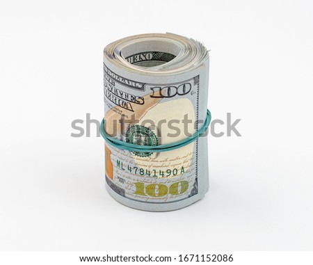 Stack of American dollars tied with a rubber band for money