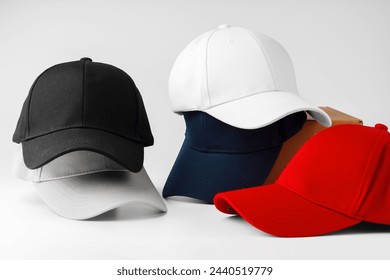 Stack of Assorted Baseball Caps on a White Background