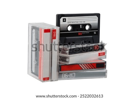 A stack of audio cassettes. Close-up of an audio cassette with a sticker without text.  Analog storage medium. Cassettes for audio recordings and music. 