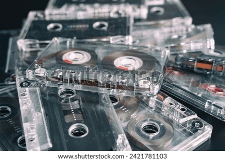 A stack of audio tape cassettes on black background. Retro vintage music concept.