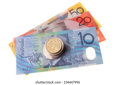 A Stack Of Australian Coins Topped With A One Dollar Coin Sitting On Top Of Three Bank Notes Isolated On White Background