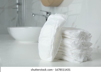 Stack Of Baby Diapers On Counter In Bathroom