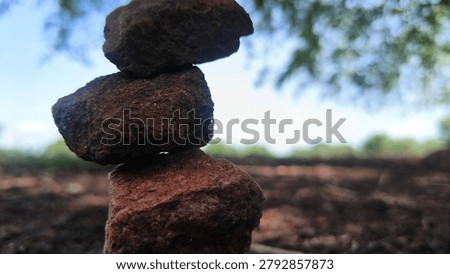Stack of balancing rocks on the ground in a natural outdoor environment
