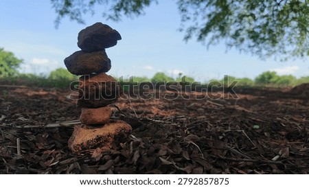 Stack of balancing rocks on the ground in a natural outdoor environment
