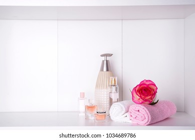 Stack of bath towels with rose on light background - Powered by Shutterstock