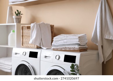 Stack of bed sheets on washing machine in laundry room