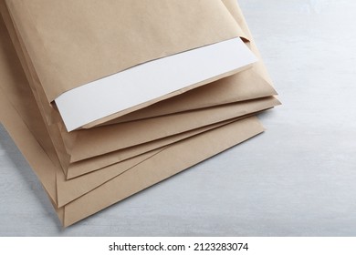 Stack Of Big Kraft Paper Envelopes On Light Table, Closeup