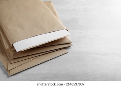 Stack Of Big Kraft Paper Envelopes On Light Table, Closeup