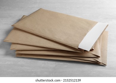 Stack Of Big Kraft Paper Envelopes On Light Table, Closeup