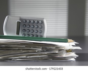 stack of  bill and calculator