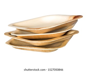 Stack of biodegradable single use plates made from dried palm leaf on white background