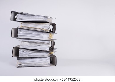 stack of black file folders full of documents against white background, space for your text - Shutterstock ID 2344952573