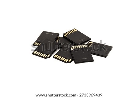 Stack of black SD memory cards on white background