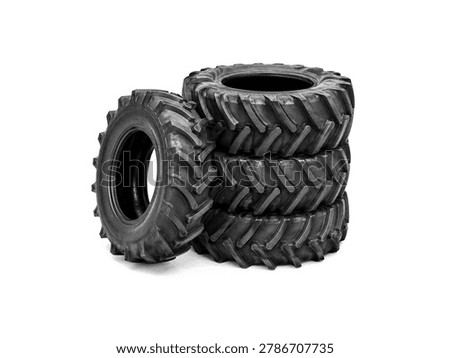 Stack of black tractor tires isolated on white background.