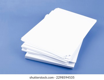Stack of blank A4 paper sheets on blue background.