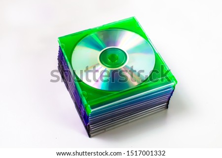 A Stack of Blank Burnable, Recordable, Writeable & Rewriteable CDs & DVDs in Multi-color and Black Slim Jewel Cases in the Middle of a Blank Background