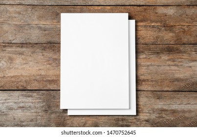 Stack Of Blank Paper Sheets For Brochure On Wooden Background, Top View. Mock Up