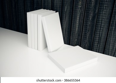 Stack Of Blank White Books Leaning On Dark Wooden Wall. Mock Up, 3D Render