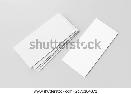 Stack of blank white DL flyers or brochures and one separate one on the right side for mockup isolated on light grey background