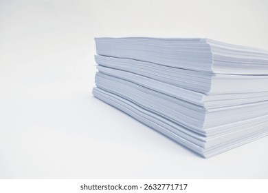 Stack of blank white sheets of paper arranged neatly on a white surface.  The paper is in multiple layers, showing the layered structure of the stack.