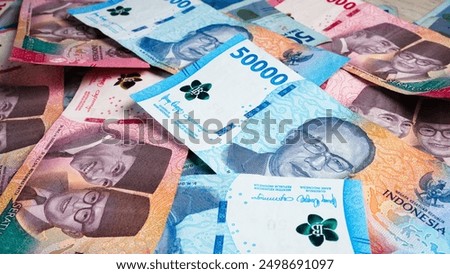 Stack of Blue One Hundred Thousand Rupiah and Fifty Thousand Rupiah Banknotes. Close-up photo of One Hundred Thousand Rupiah and Fifty Thousand Rupiah banknotes. Indonesian Currency