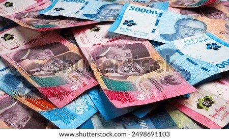 Stack of Blue One Hundred Thousand Rupiah and Fifty Thousand Rupiah Banknotes. Close-up photo of One Hundred Thousand Rupiah and Fifty Thousand Rupiah banknotes. Indonesian Currency