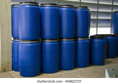 Stack of blue plastic barrels or  blue plastic gallons at industry or factory.