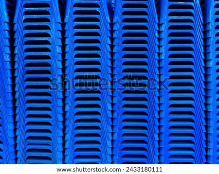 stack of blue plastic chairs