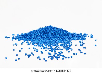 Stack of a blue plastic polymer granules on a white background, copy space