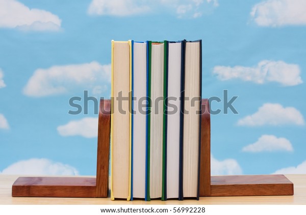 A stack of book between book end with a sky\
background, Learning