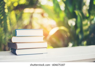 Stack of book on nature background.