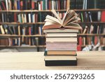 stack of books against the background of library, stack of books in front of library, books on wooden table, education, High quality book photography, Best Book Photo, Edinburgh;Chicago;Medellín