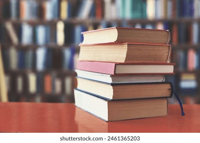 stack of books against the background of library, stack of books in front of library, books on wooden table