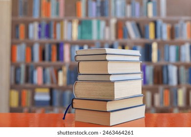 stack of books against the background of library, stack of books in front of library, books on wooden table, High quality book photography - Powered by Shutterstock