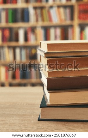 stack of books against the background of library, stack of books in front of library, books on wooden table, education, High quality book photography, Best Book Photo, we read famous writers