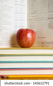 Stack Of Books And Apple With A Vintage Report Card