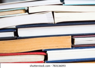 Stack of books background. many books piles. Books and reading are essential for self improvement, gaining knowledge and success in our careers, business and personal lives