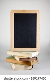 stack of books with blackboard