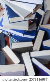 stack of books, close up. Open book on the table in library. Back to school concept.