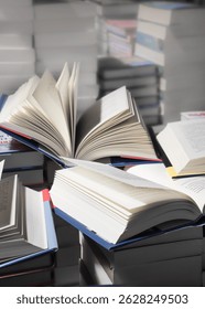 stack of books, close up. Open book on the table in library. Back to school concept. Open book on table with blur bookshelf background