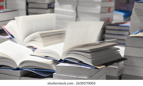 stack of books, close up. Open book on the table in library. Back to school concept. Open book on table with blur bookshelf background
