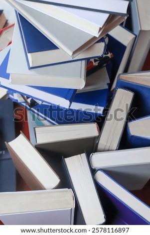 stack of books, close up. Open book on the table in library. Back to school concept.