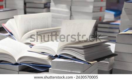 stack of books, close up. Open book on the table in library. Back to school concept. Open book on table with blur bookshelf background