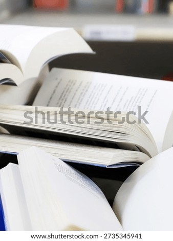stack of books, close up. Open book on the table in library. Back to school concept. Open book on table with blur bookshelf background