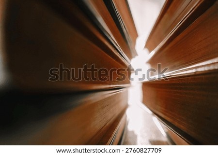Stack Of Books Close Up. Reading and learning concepts.Close-up of book pages and sun glare. Books in the suns rays. 
