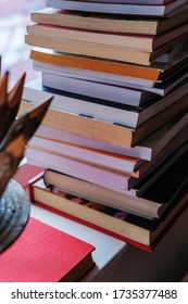 Stack of books closeup by the window, good reed and education material