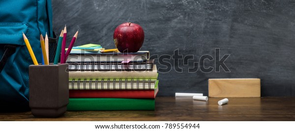 stacks of books with school supplies